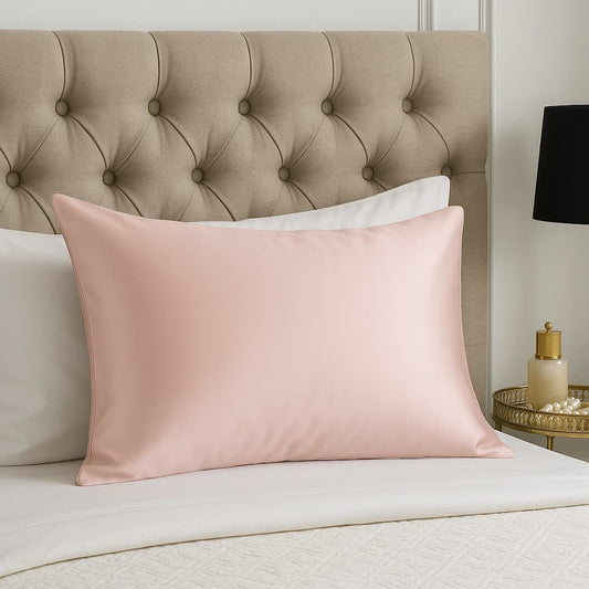taie d'oreiller en soie rose sur un lit blanc 